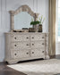 Bruchandi King Upholstered Panel Bed with Mirrored Dresser